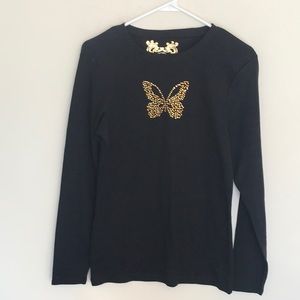 Gold studded butterfly decorates this black top